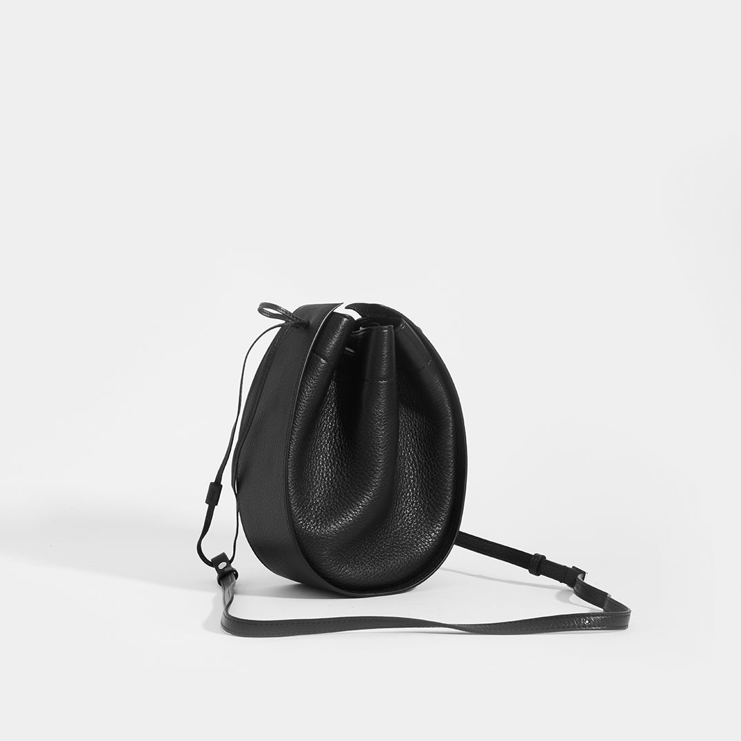 THE ROW Round Drawstring Leather Crossbody in Black | COCOON