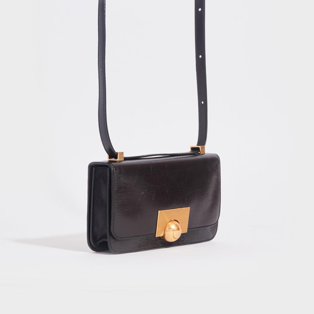 Side view of the BOTTEGA VENETA The Classic Mini Leather Shoulder Bag in Fondente