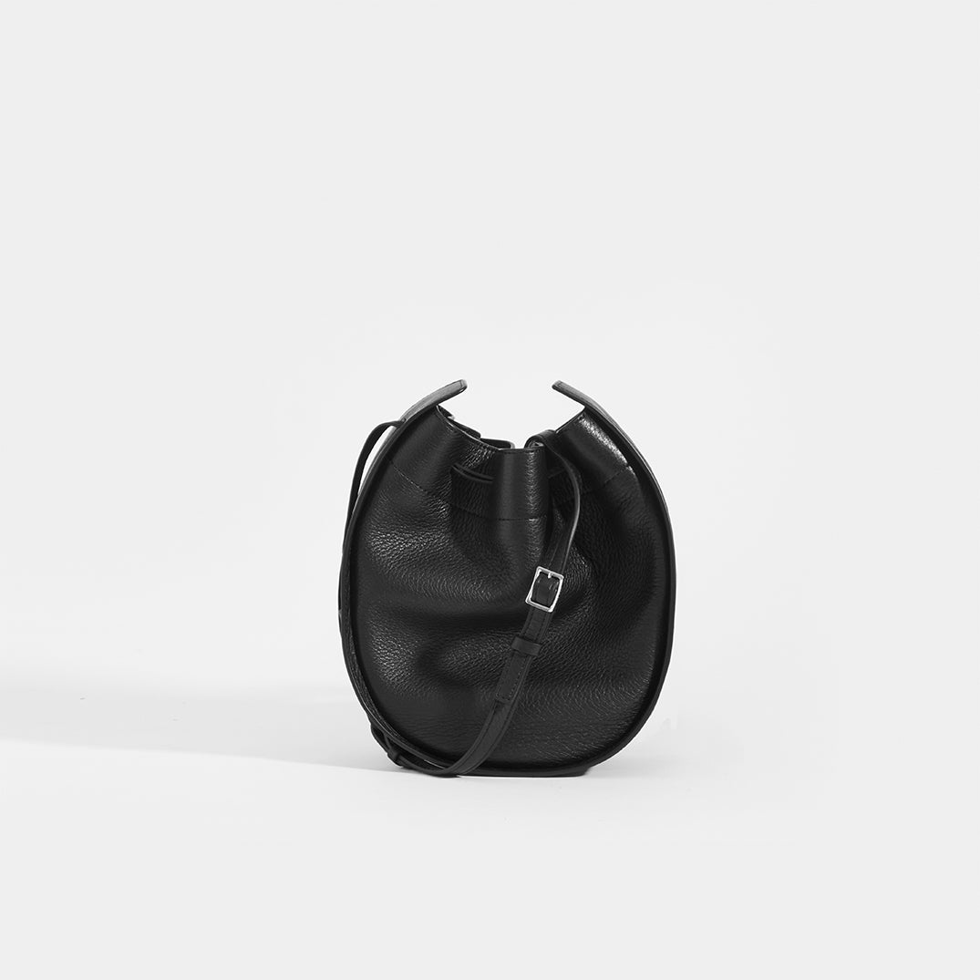 THE ROW Round Drawstring Leather Crossbody in Black | COCOON